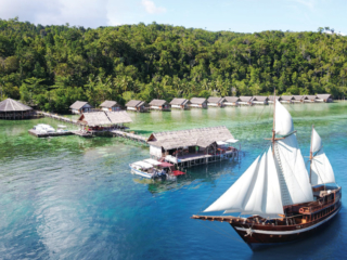 our Coralia Liveaboard in front of our resort Papua Explorers in Raja Ampat
