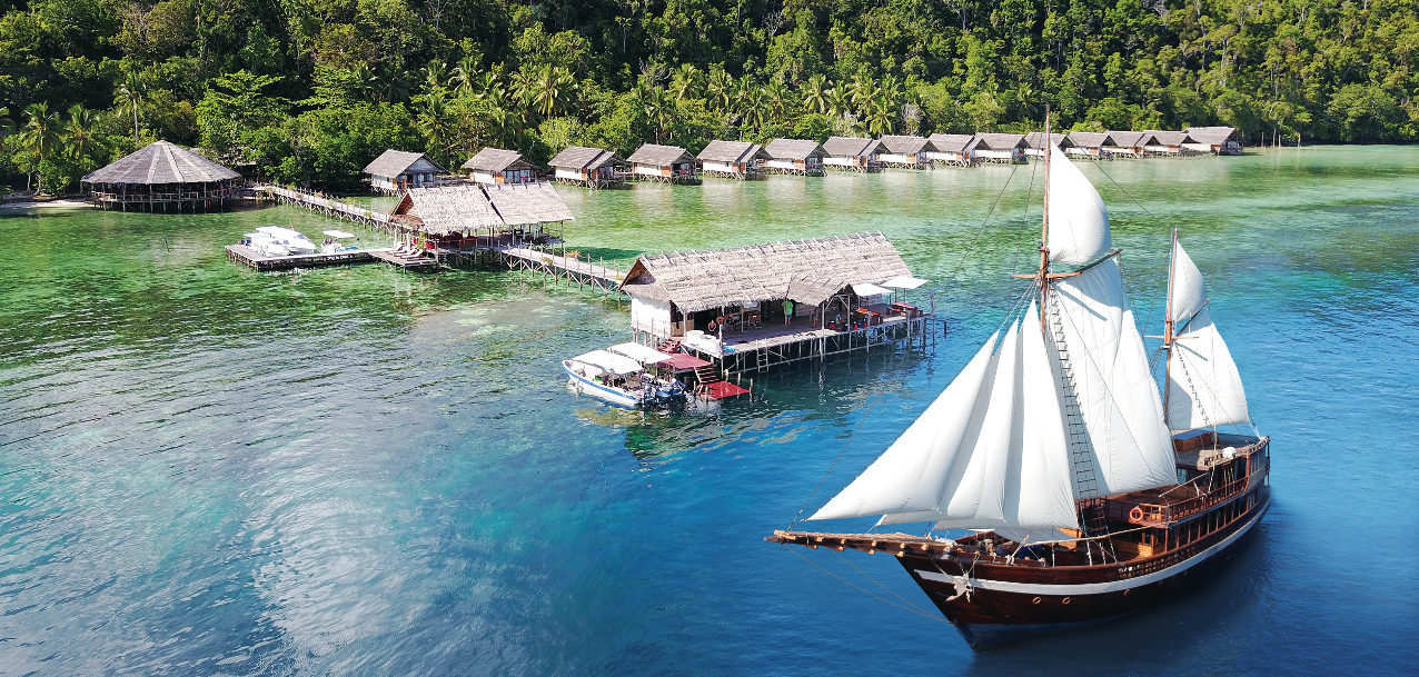 our Coralia Liveaboard in front of our resort Papua Explorers in Raja Ampat