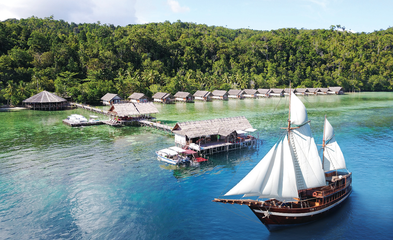 our Coralia Liveaboard in front of our resort Papua Explorers in Raja Ampat