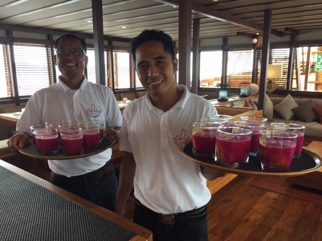members of our friendly service team serving drinks on Coralia Liveaboard Indonesia