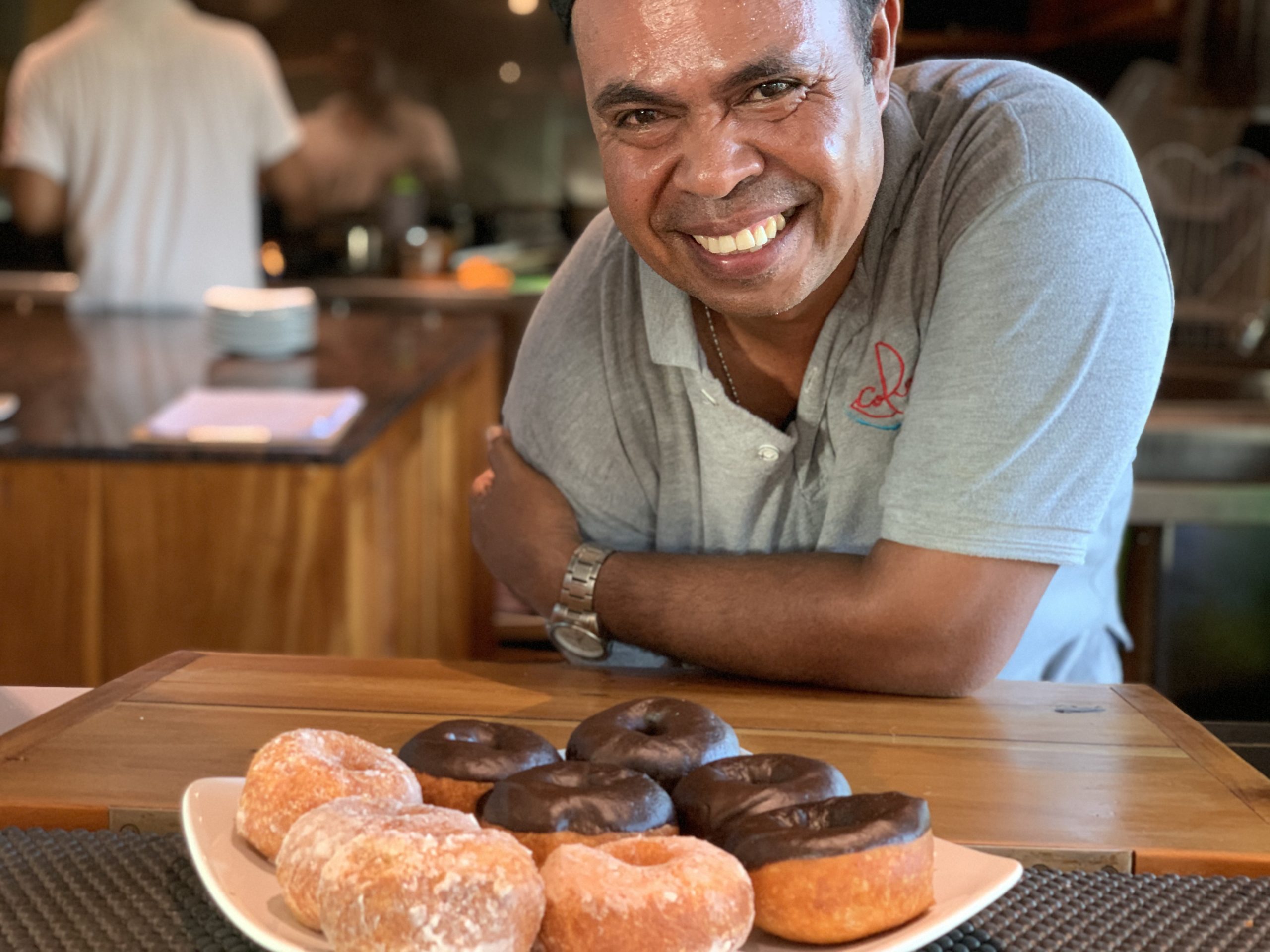 our smiling onboard chef Joe presenting his donuts, a coralia liveaboard food favorite