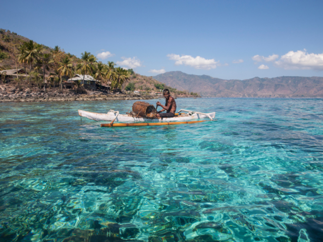 an Alor local in his kayak on the ocean in Indonesia