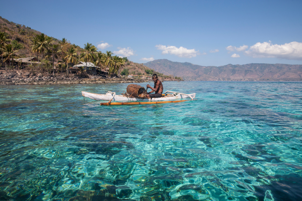 an Alor local in his kayak on the ocean in Indonesia
