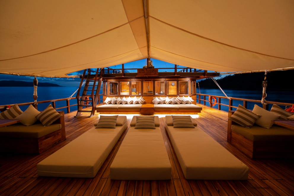 Sunbeds and seating areas on our spacious upper deck aboard Coralia Liveaboard in Indonesia