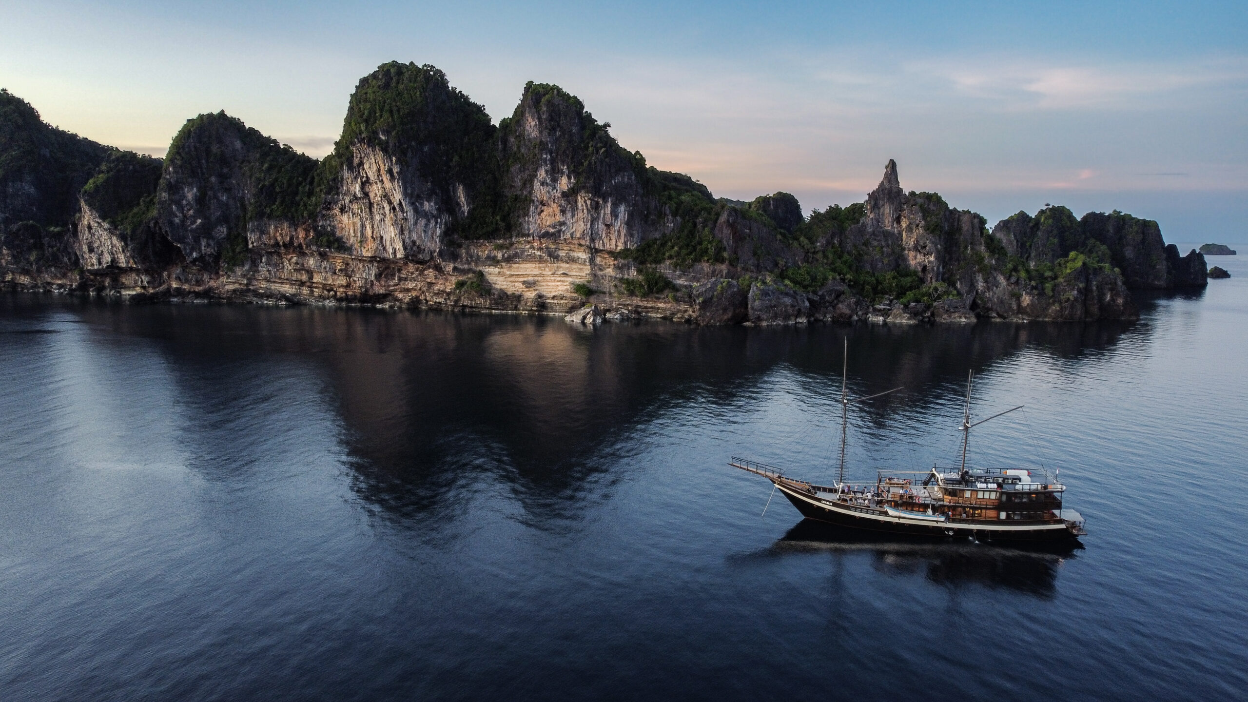 Coralia liveaboard sailing at Balbulol in Raja Ampat, Indonesia.
